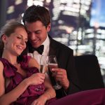 Elegant couple drinking Champagne at night