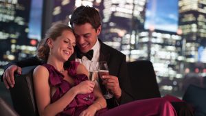 Elegant couple drinking Champagne at night